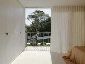 Master bedroom with full-height windows and private balcony 01