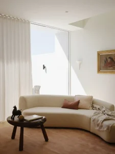 Pamment Projects Coogee Duplex Living Room White Curved Sofa Pink Rug Curtains